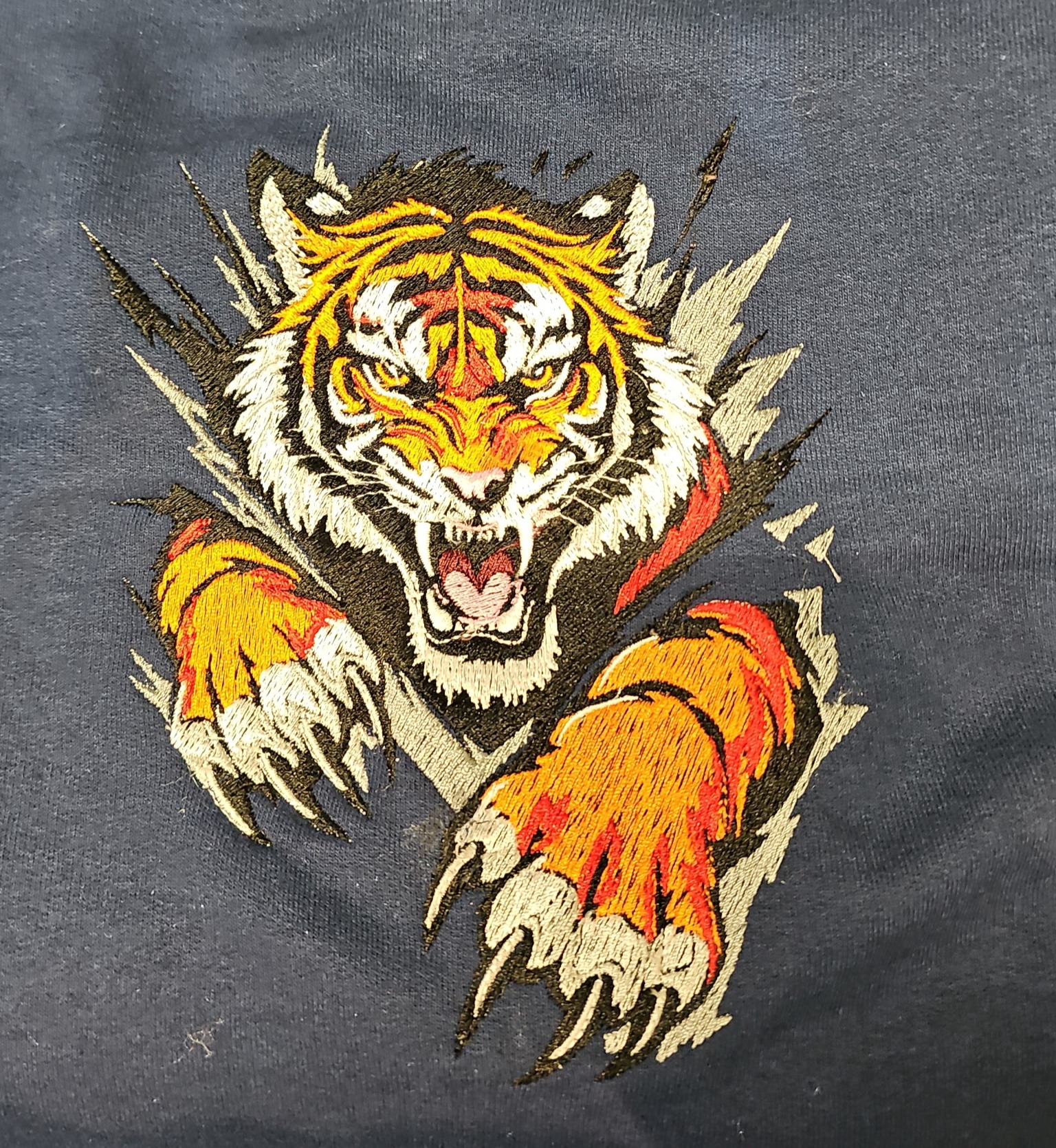 Tiger embroidery stitched on dark apparel