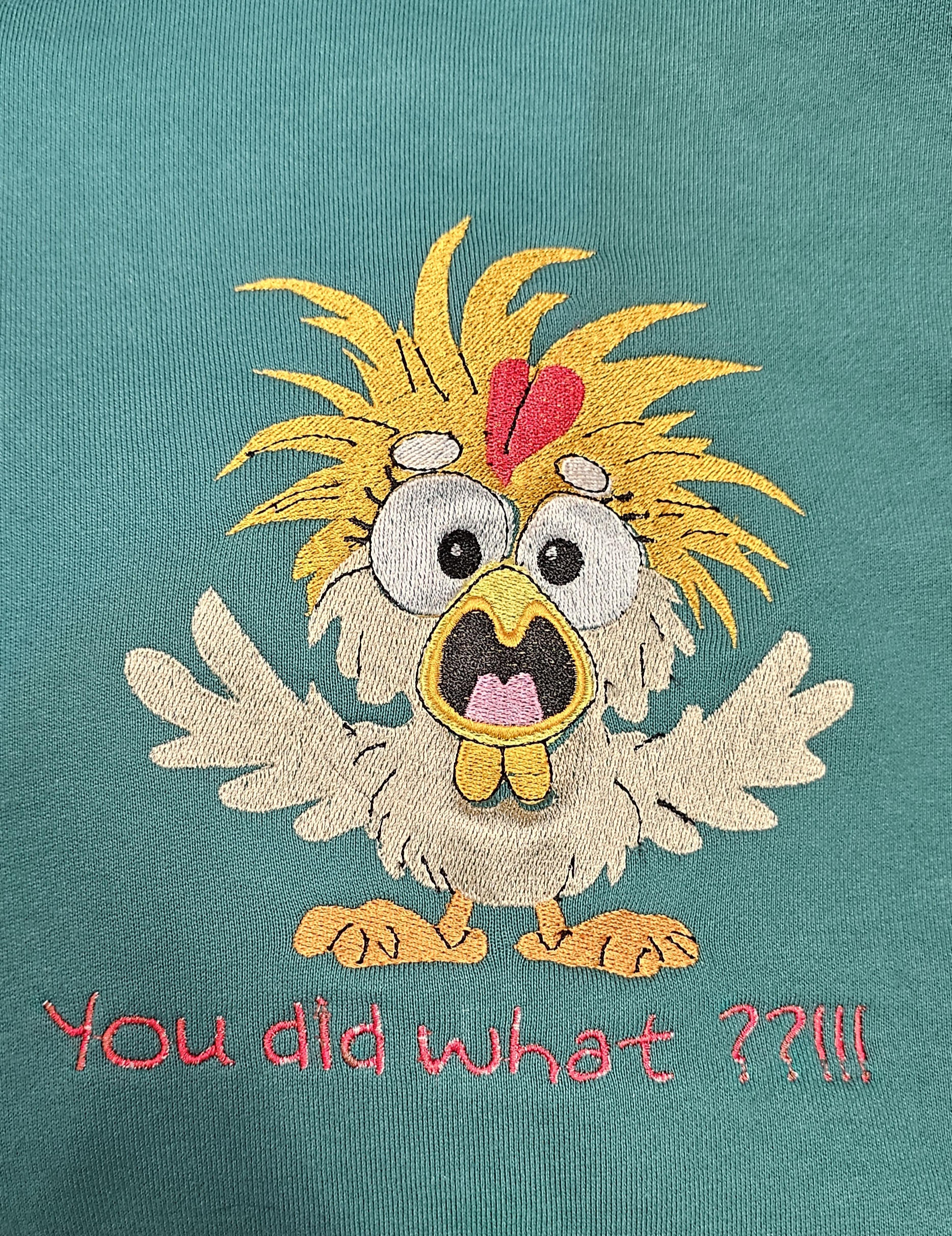 Chicken embroidery stitched on teal apparel