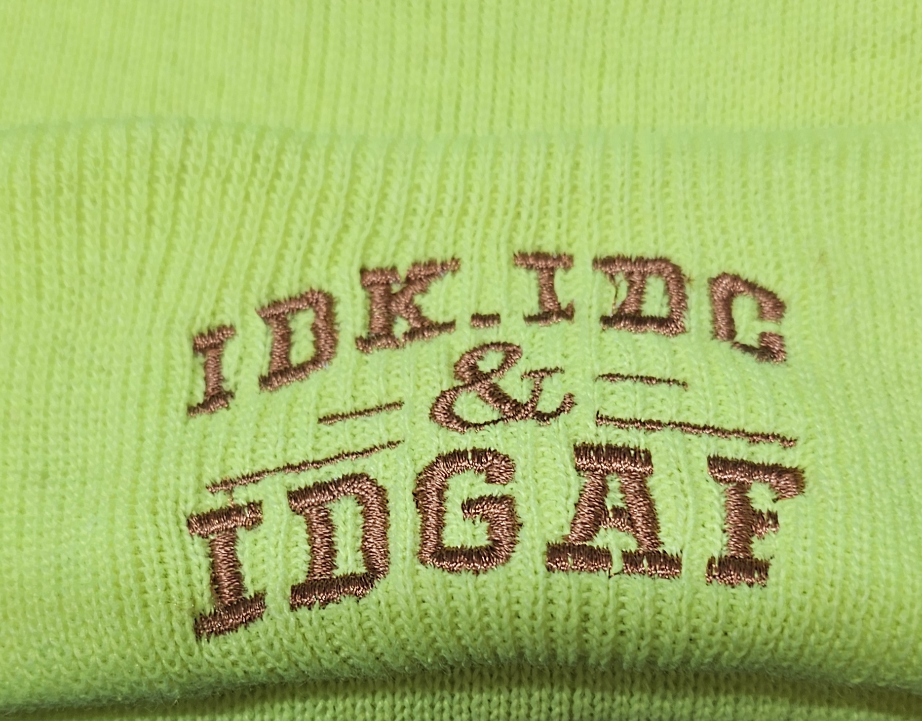 IDK, IDC & IDGAF lettering embroidered on a neon yellow beanie