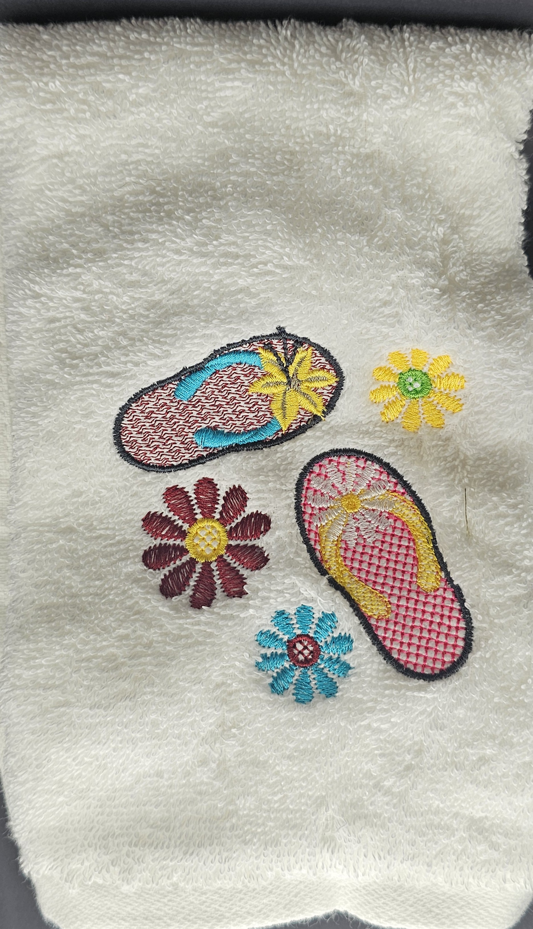 White towel with flip flop embroidery