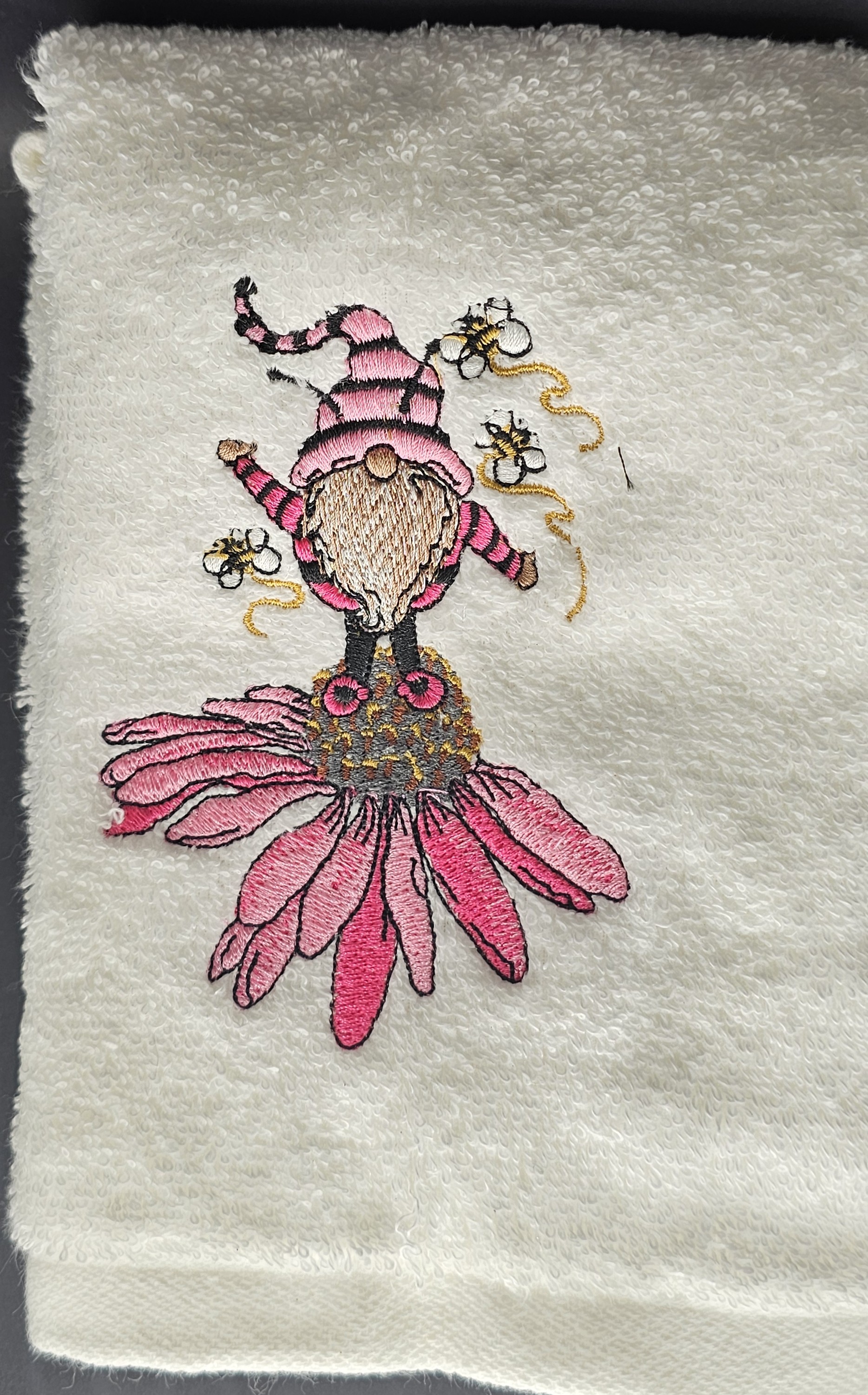White towel with pink gnome embroidery